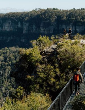 People walking over a bridge along the Grand Cliff Top walk