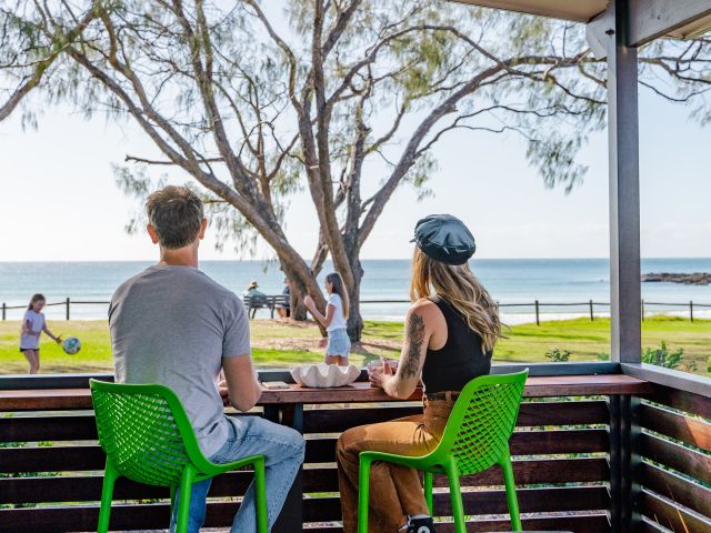family on deck of villa at Woolgoolga Beach Holiday Park