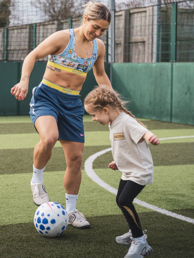 Mum and child playing soccer