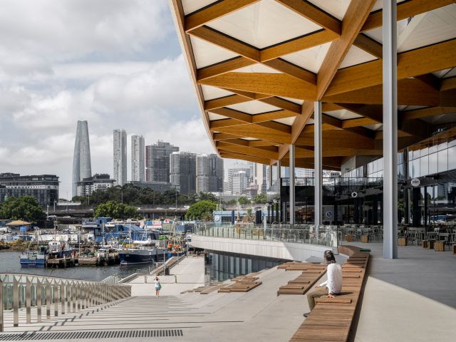 A woman sitting at the Civic Plaza at the Sydney Fish Market