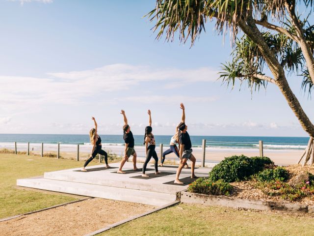 a beach yoga session at Elements of Byron