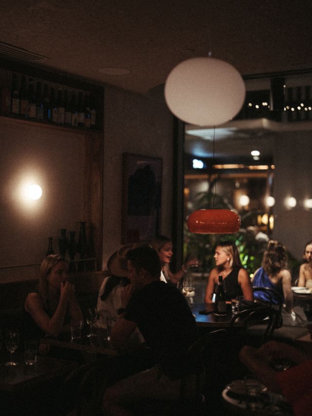 Interior of Bar Heather with patrons dining at night