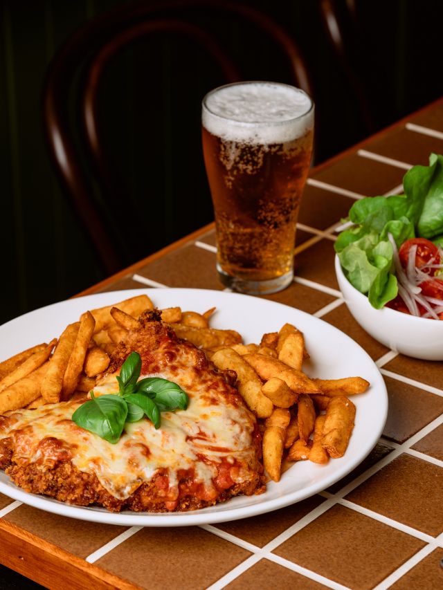 A scrumptious plate of food and a beer.