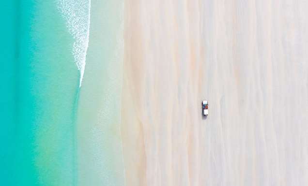 car on cable beach at sunrise