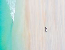 car on cable beach at sunrise