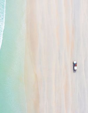 car on cable beach at sunrise