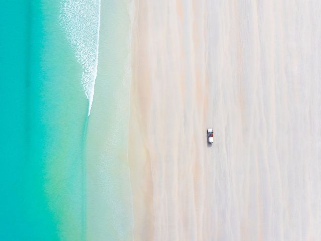 car on cable beach at sunrise