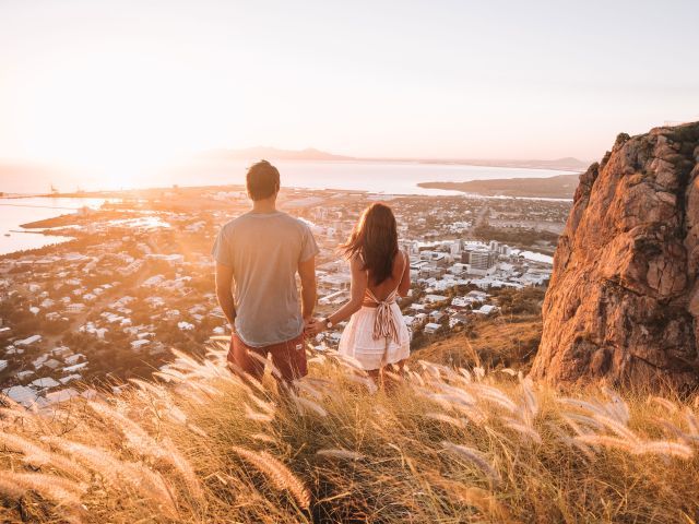 couple holiding hands at the top of castle hill in townsville