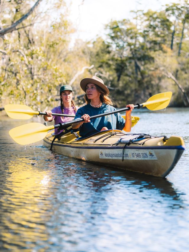 Two women kayaking during a Noosa experiences.