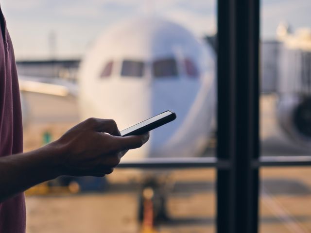 Man on his phone at the airport