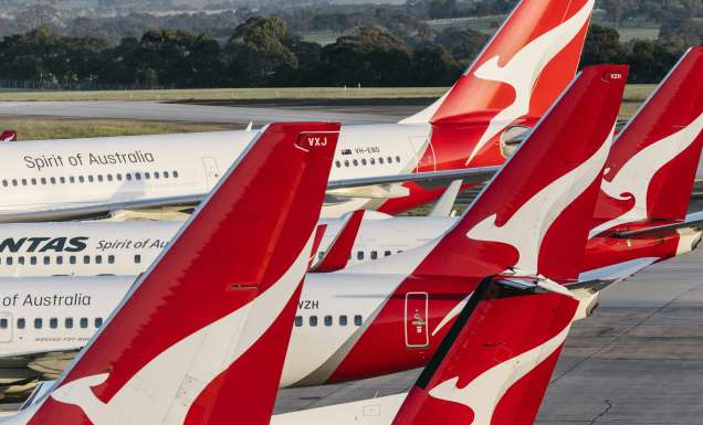 Qantas planes sitting together at airport