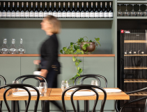 A stroll through Austin’s Wines, lined with bottles and warm dining spaces.