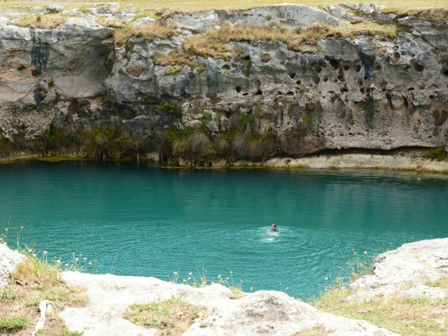 Man swimming in blue lake in Mount Gambier in SA