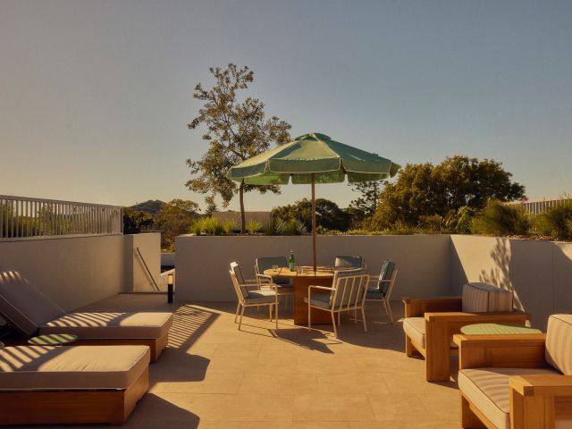 Seating areas at The Bonobo by Raes rooftop pool