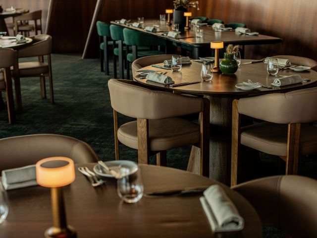The interiors of Bommie Restaurant, featuring modern coastal design with warm lighting and elegant detailing.