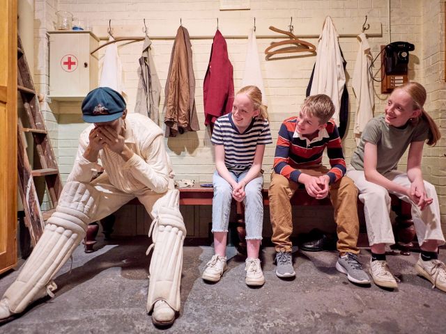 kids posing with donald bradman statue in bowral's The Bradman Museum