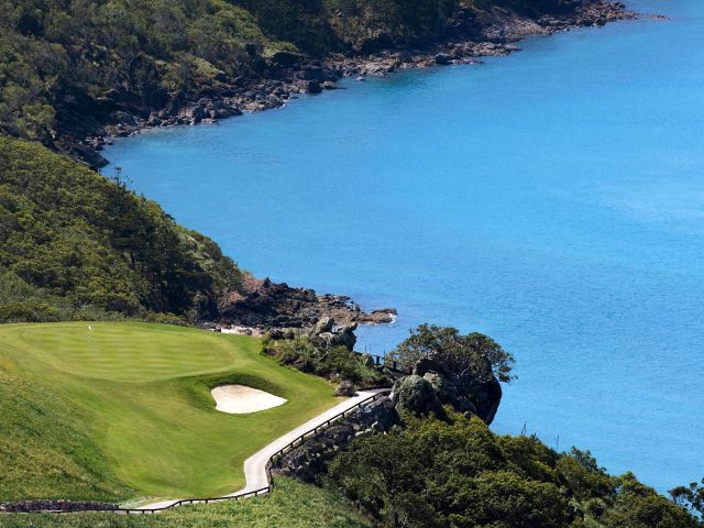 An 18-hole golf course set against sweeping ocean views.