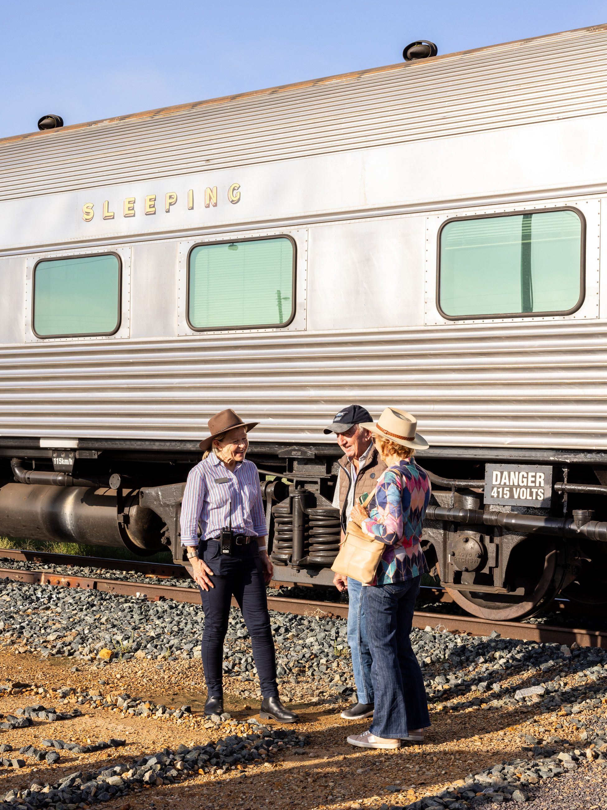 Guests wait beside the train