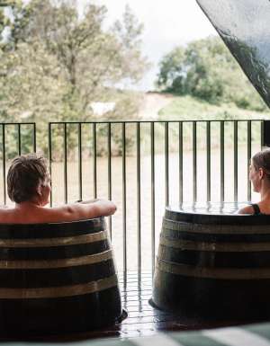 Couple soak in barrels at Metung Hot Springs