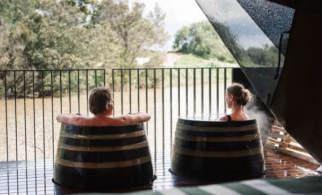 Couple soak in barrels at Metung Hot Springs