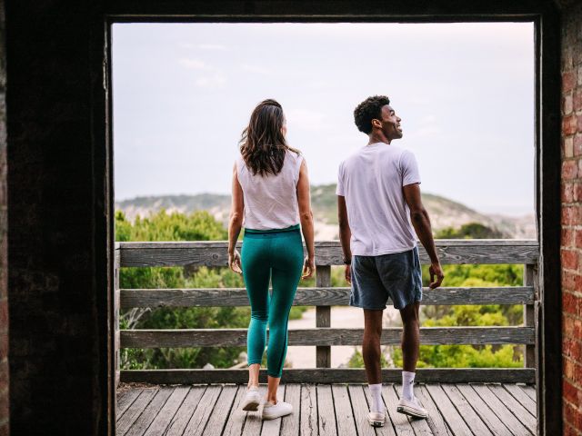 couple walking out of Fort Nepean Tunnels with copastal views below