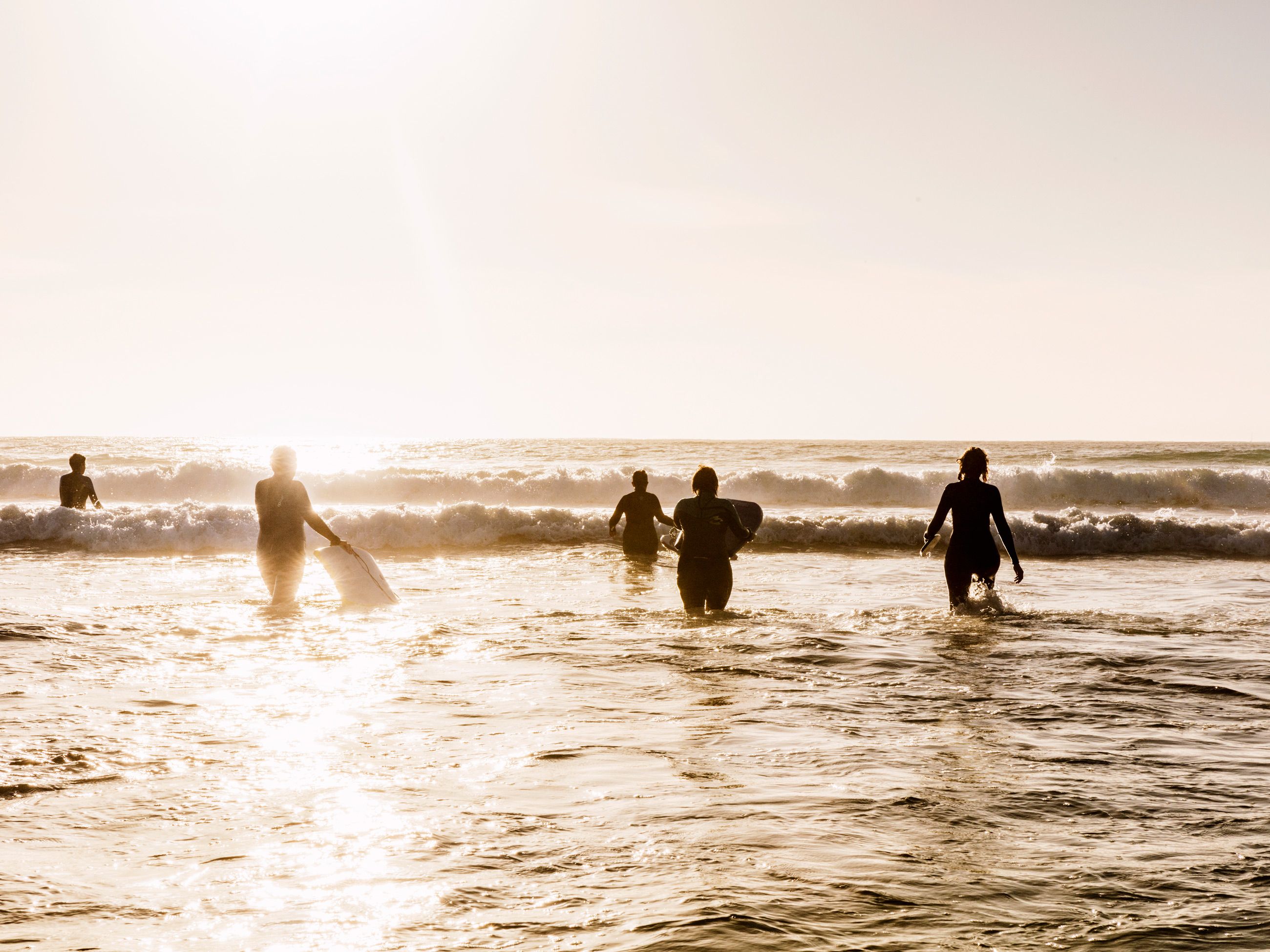 People surfing at sunrise in Port Fairy on the Great Ocean Road