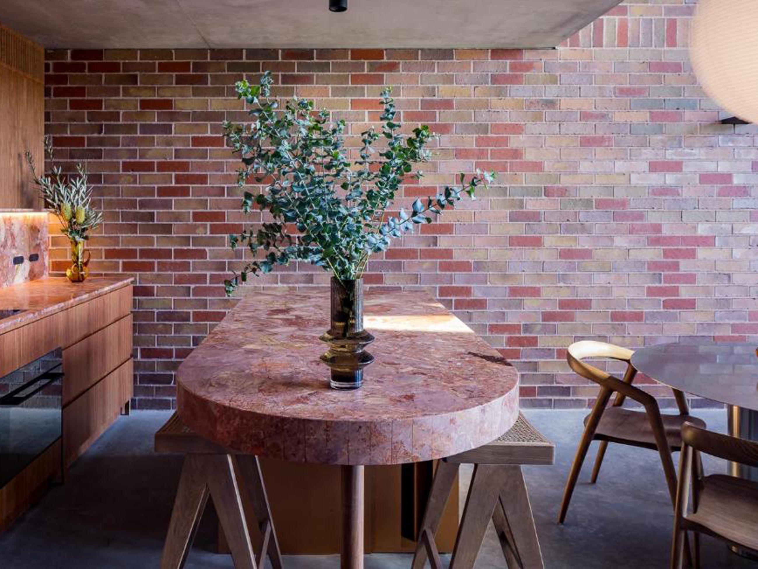 An oval-shaped kitchen island made from marble
