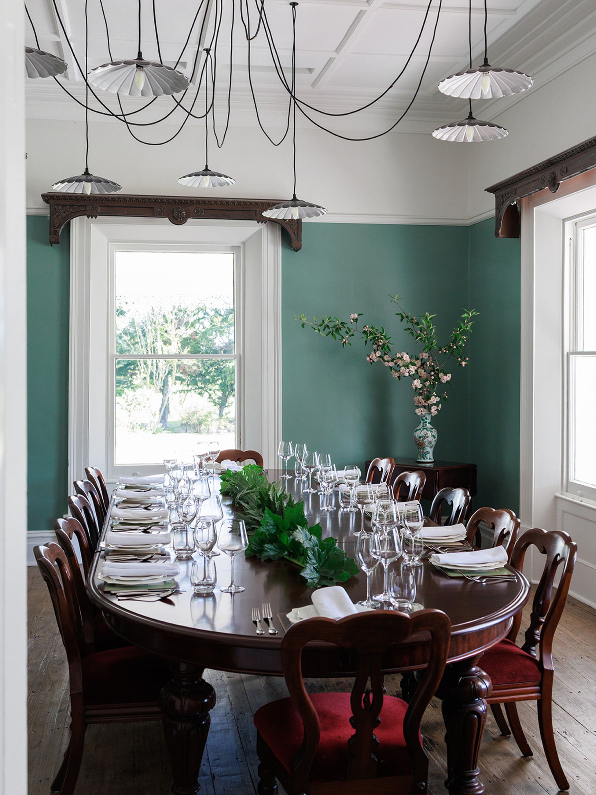 The dining room with teal walls at Littlebourne Guest House