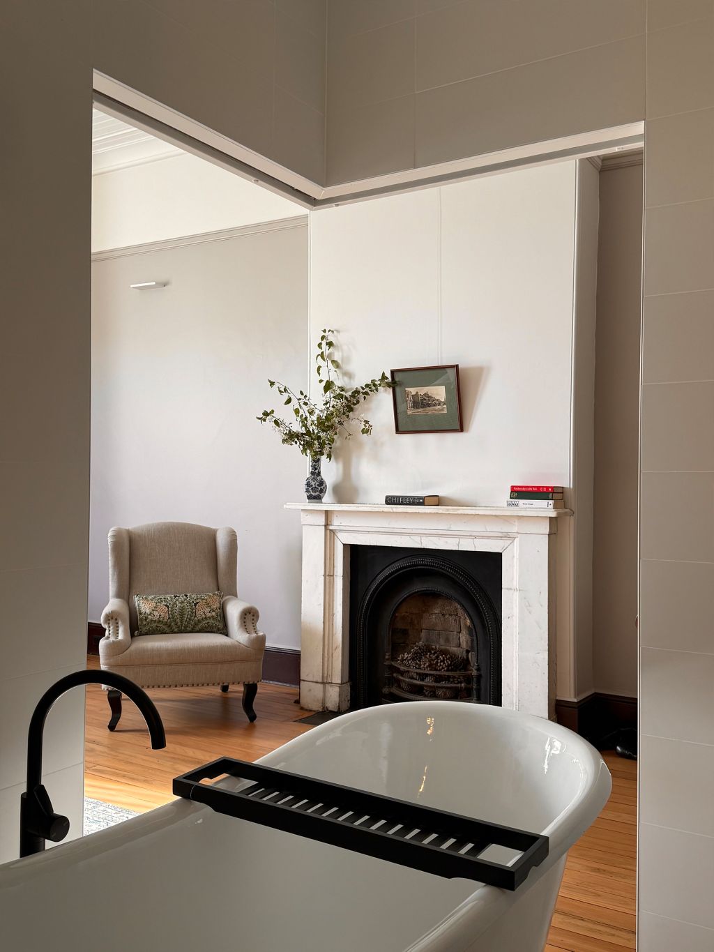 A freestanding bath facing a fireplace