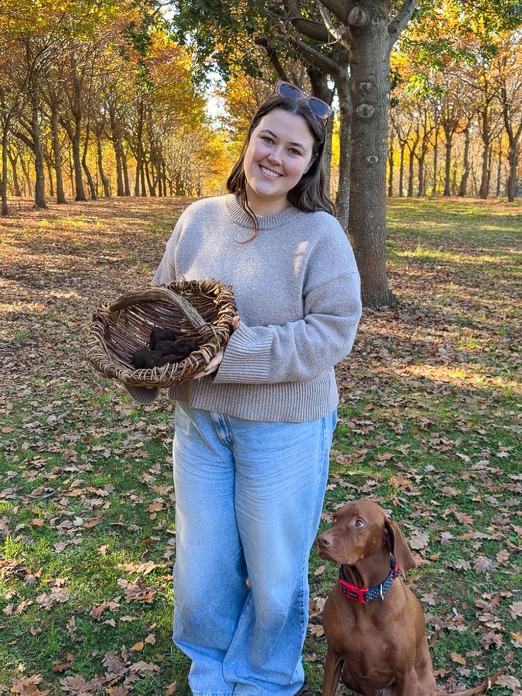 Emily Murphy and George the truffle hunting dog with basket of truffles at The Truffle Farm, Tasmania