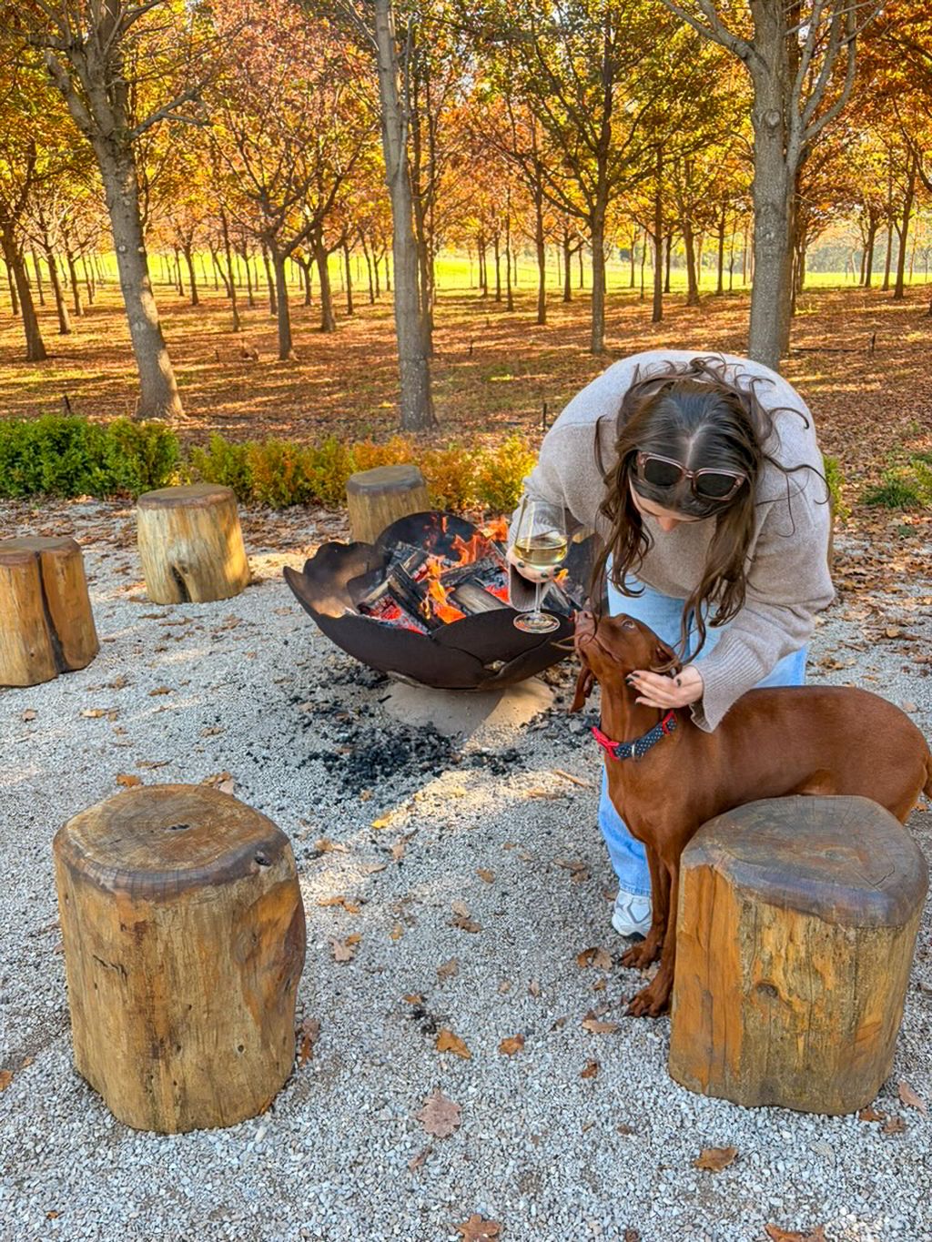 Emily Murphy and George the truffle hunting dog by the firepit at The Truffle Farm, Tasmania