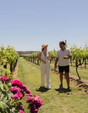 Couple walking through vineyard in Stanthorpe, Queensland