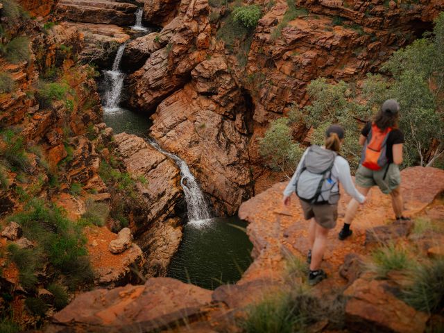 Two women hiking to John Hayes Rockhole, one of the unforgettable experiences during the best time to explore the NT.