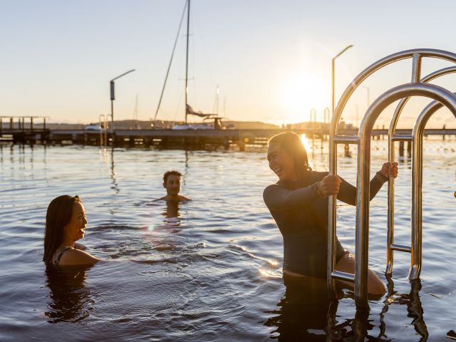 three people swimming in lake macquarie