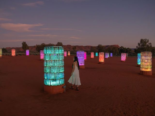 A woman admiring The Light Towers, one of the must-see attractions during the best time to explore the NT.
