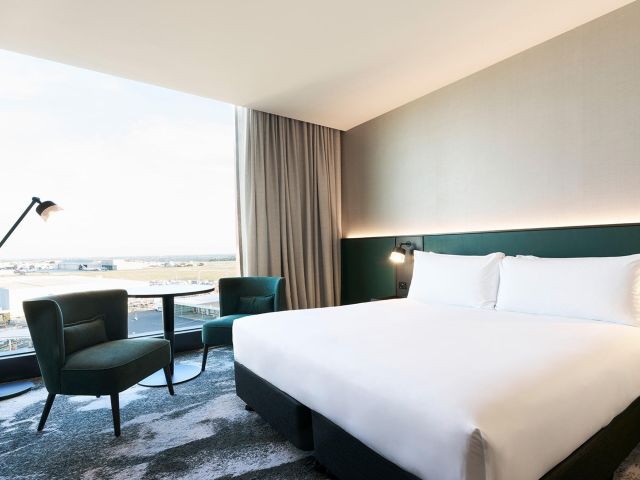 The guest room and plush bed at Novotel Melbourne Airport, designed for a comfortable and restful stay.