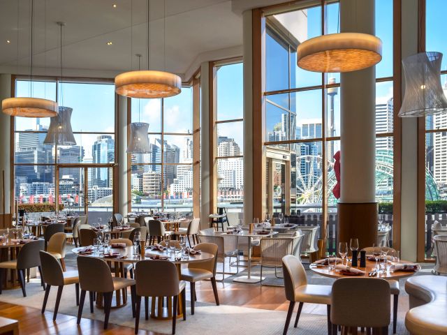 The modern dining space at The Ternary in Novotel Sydney Darling Harbour with views of Darling Harbour.