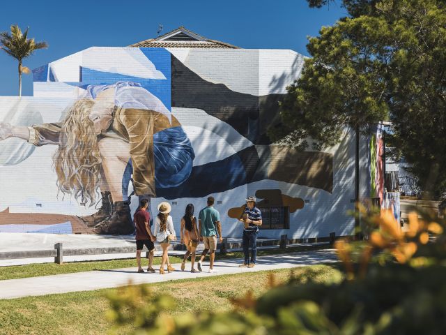 tour group walking in front of toowoomba street art