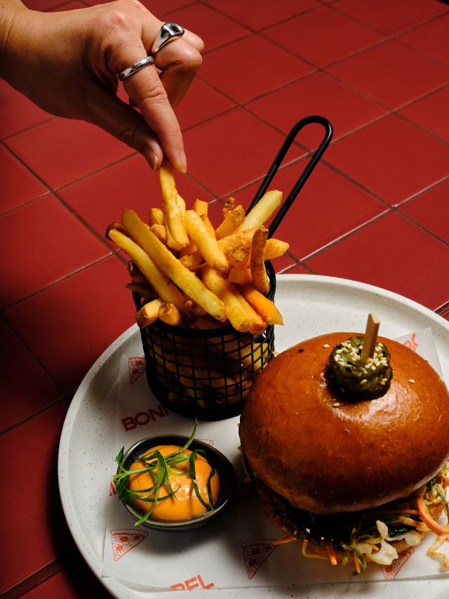 A juicy burger and crispy fries from Bonnibel, a delicious stop on the ultimate Melbourne weekend.