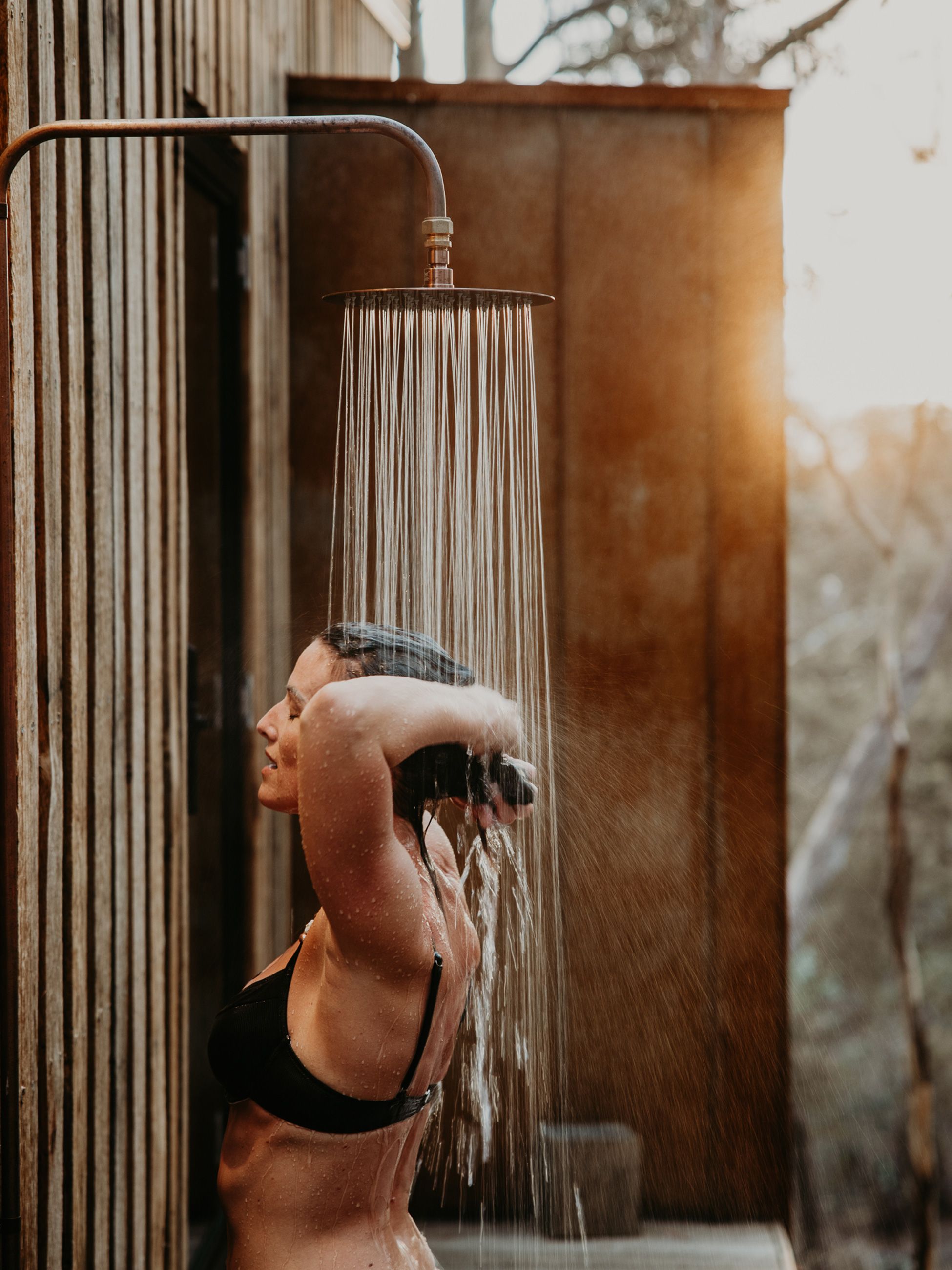 Woman in the outdoor shower at Arden Bathhouse