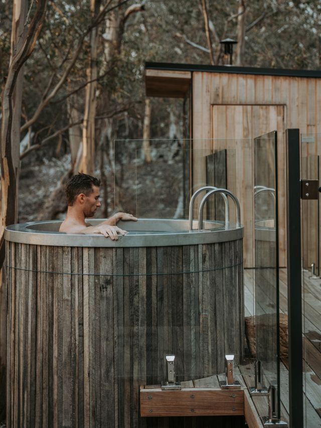 Man in cold plunge tub at Arden Bathhouse 