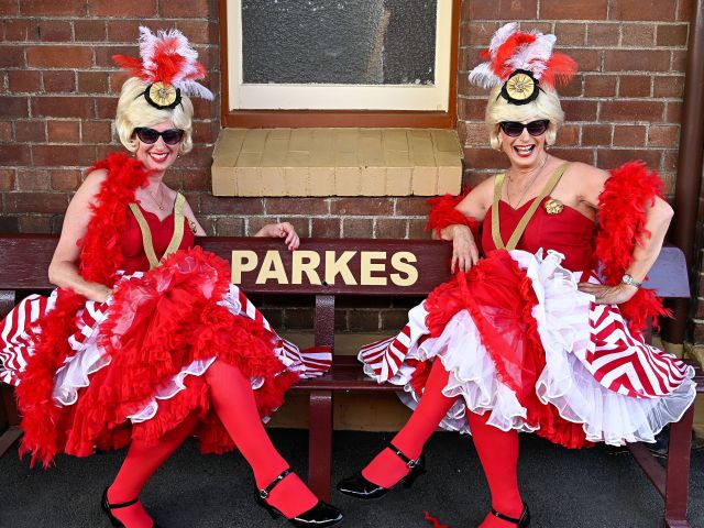 impersonators sitting on a park bench at the Parkes Elvis Festival