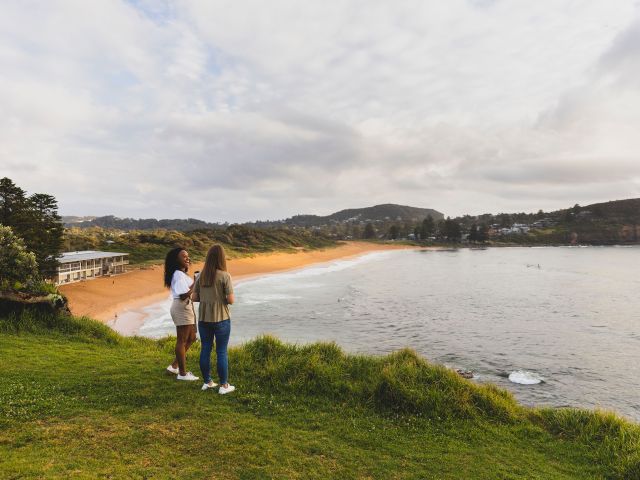 two women looking over avalon beach in sydney