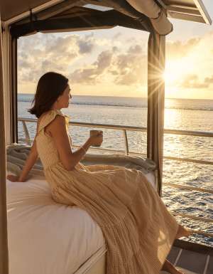 woman at reefsleep on bed during sunset cruise whitsundays