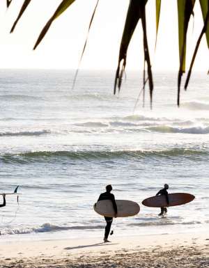 surfers on Kingscliff beach on The Tweed which made lonely planet's 2027 Top Experiences Hotlist