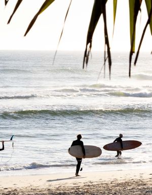 surfers on Kingscliff beach on The Tweed which made lonely planet's 2027 Top Experiences Hotlist