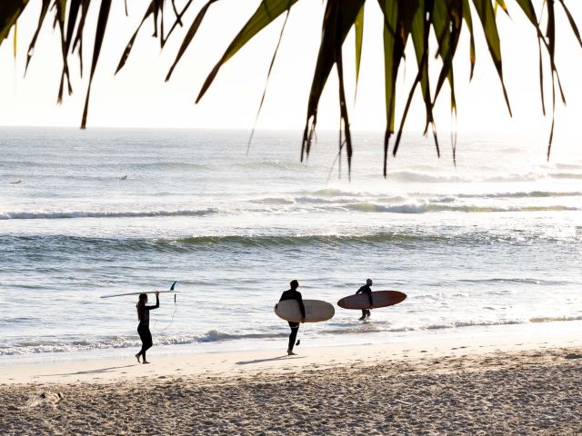 surfers on Kingscliff beach on The Tweed which made lonely planet's 2027 Top Experiences Hotlist