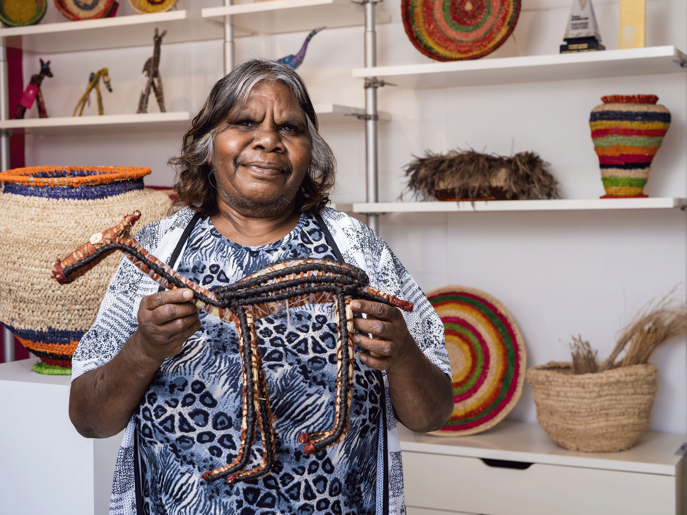 member of Tjanpi Desert Weavers exhibiting her work