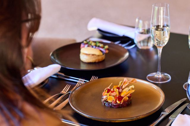 A beautifully presented dish paired with champagne.