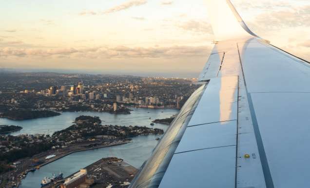 plane flying over sydney harbour